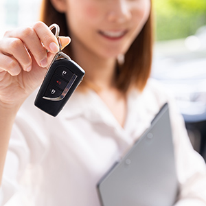 woman holding rental car key
